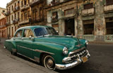 A+car+parked+in+front+of+a+building%2C+Havana%2C+Cuba