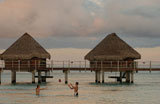 Thatched+buildings+on+stilts+in+the+sea%2C+Moorea%2C+Tahiti%2C+French+Polynesia%2C+South+Pacific