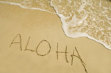 High+angle+view+of+Aloha+written+in+sand