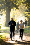 Young+couple+jogging+on+a+dirt+road+in+a+park