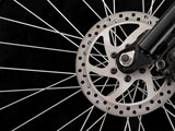 Bicycle+disc+brakes+isolated+on+a+black+background.+