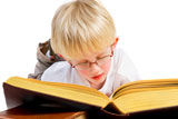 Little+blond+boy+is+reading+a+thick+good+book+