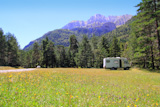 Camper+autocaravan+meadow+in+Pyrenees+mountain+sunny+day+pine+trees+forest