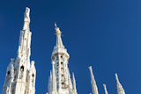 Detail+of+Duomo+di+Milano+%28Milan+Cathedral%29+with+the+famous+%27Madonnina%27+%28the+symbol+of+Milano%29+atop+the+main+spire+of+the+cathedral%2C+a+baroque+gilded+bronze+artwork.