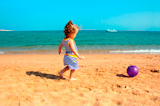 little+girl+playing+with+ball+on+beach