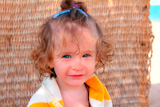smiling+little+girl+in+towel+on+beach