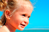 smiling+happy+little+girl+on+beach+near+sea