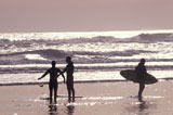 Surfers+Standing+on+the+Beach