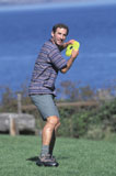 Caucasian+Man+Playing+Frisbee+Near+A+Lake