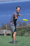 Caucasian+Man+Playing+Frisbee+Near+A+Lake