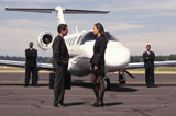 Businessman+and+Businesswoman+Talking+Outside+Airplane
