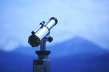 Metal+telescope+pointing+at+mountain+landscape