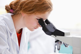 Close up of a science student looking into a microscope