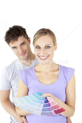 Affectionate young couple choosing colors for painting their room