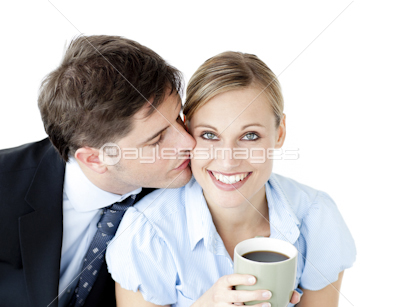 Attentive businessman kissing his girlfriend at her cheek