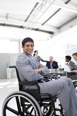 Attractive,businessman,sitting,in,a,wheelchair,with,folded,arms