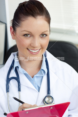Attractive young female doctor holding a clipboard