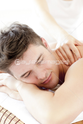 Attractive young man enjoying a back massage