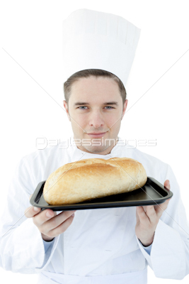 Charismatic male cook holding a bread into the camera