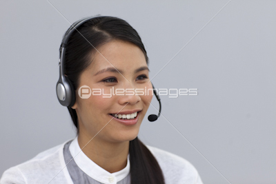 Charming young businesswoman with headset on