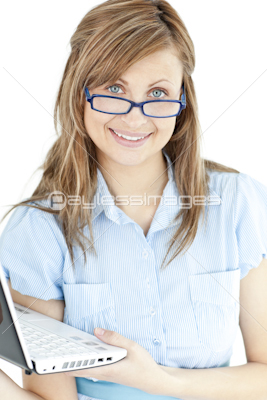 Confident businesswoman working at her laptop standing