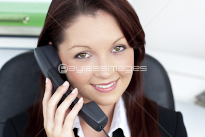 Confident young businesswoman talking on phone