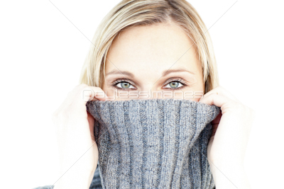 Delighted woman wearing a polo-neck-sweater smiling at the camera