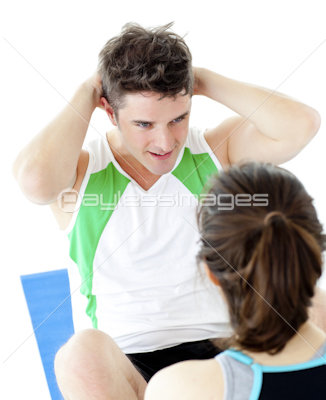 Handsome man doing fitness exercises with a woman