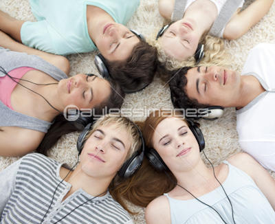 High angle of teenagers listening to music
