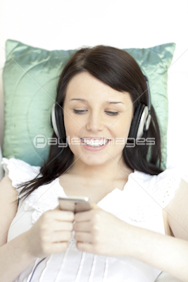 Jolly young woman listening music with headphones