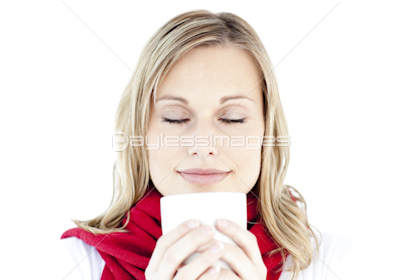 Portrait of a young woman enjoying her hot coffee in the winter