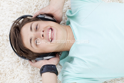 Portrait of teen guy listening to music