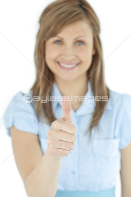 Radiant businesswoman smiling at the camera with thumb up