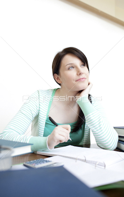 Self-assured teen girl studying at her desk