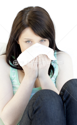 Sick cute woman blowing sitting on a sofa