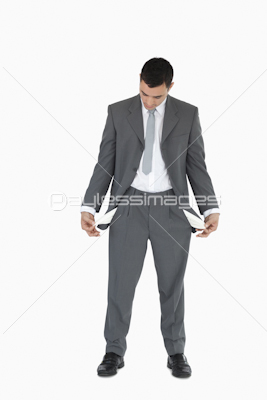 Businessman looking at empty pockets
