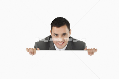 Businessman looking over wall