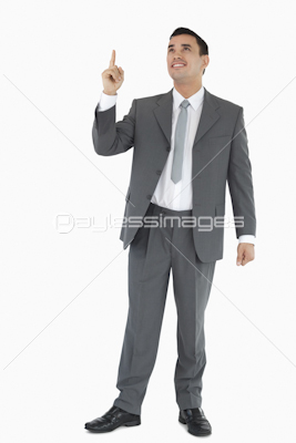 Businessman pointing and looking upwards