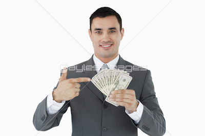 Businessman pointing at bank notes in his hand