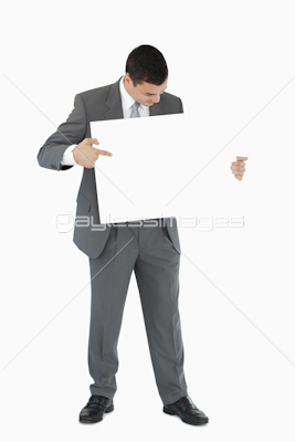 Businessman pointing at sign in his hands
