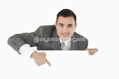 Businessman pointing at sign under him