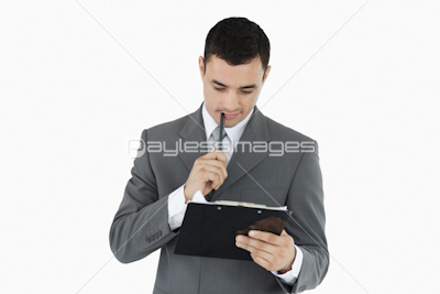 Businessman reading his notes on a clipboard
