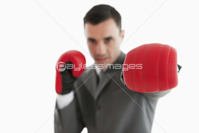 Close up of boxing glove being used by businessman