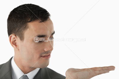 Close up of businessman looking at what he is presenting in his palm