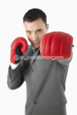Close up of businessman's fist in a boxing glove