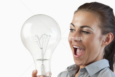 Close up of businesswoman being surprised by huge light bulb
