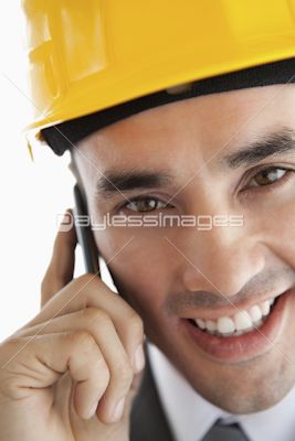 Close up of smiling architect listening to customer on the phone