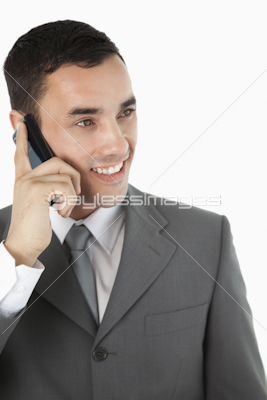 Close up of smiling businessman looking to the side while on the phone