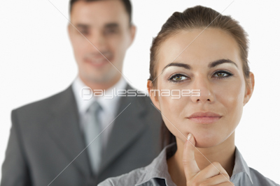 Close up of thoughtful businesswoman with colleague behind her