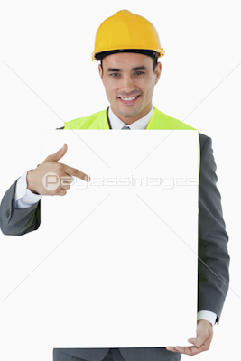 Smiling architect pointing on sign in his hands